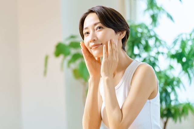 両頬を触る女性